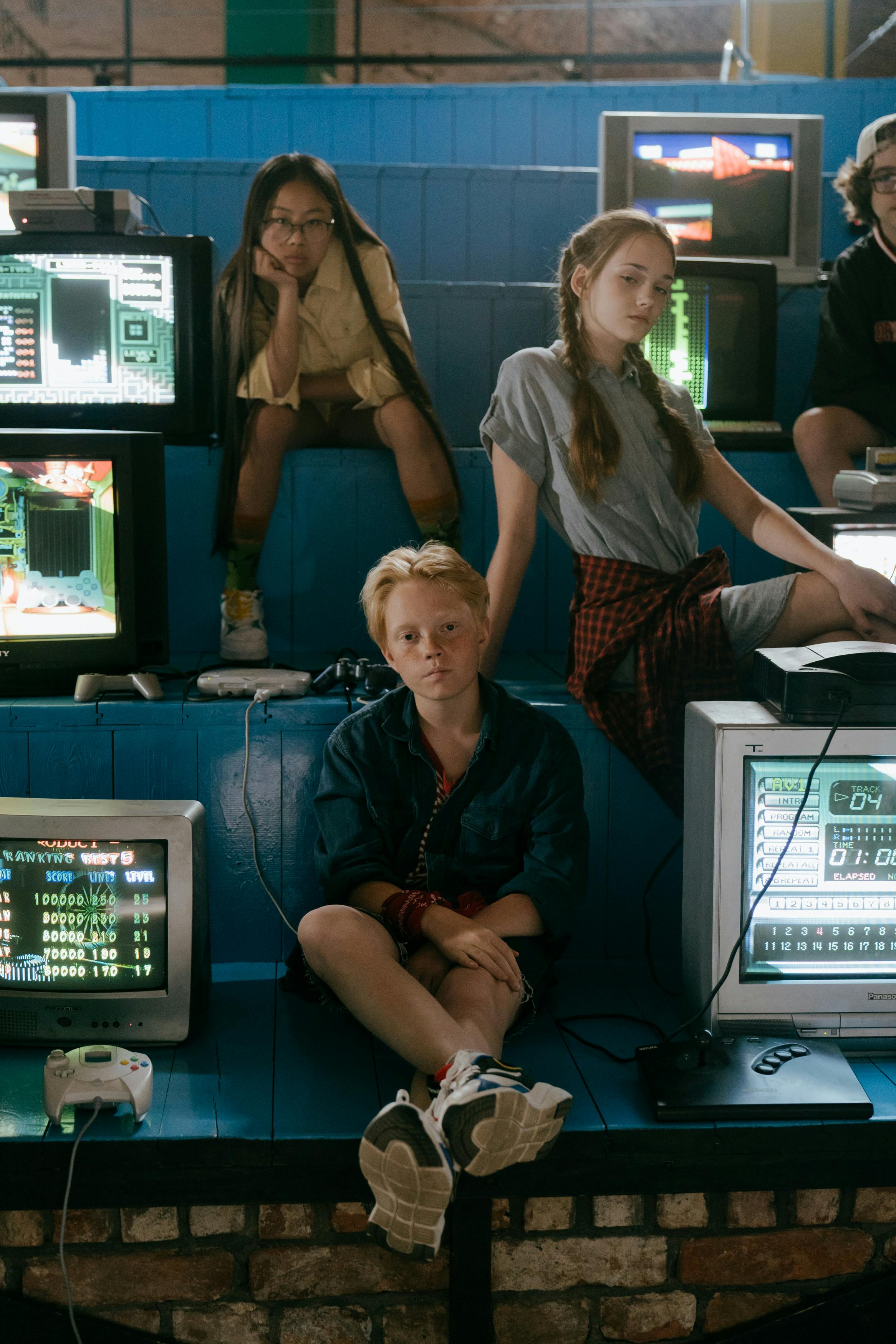 Group of teenagers enjoying classic video games in a vintage arcade setting.